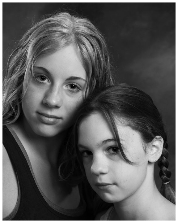 family and children portrait photographer. Close up of two young sisters black and white Child Portrait